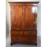 A George III Mahogany Line Inlaid Press Cupboard, the moulded cornice above two doors enclosing