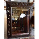 A Victorian Carved Oak Cushion Mirror with pierced carved frame, 112cms x 82cms