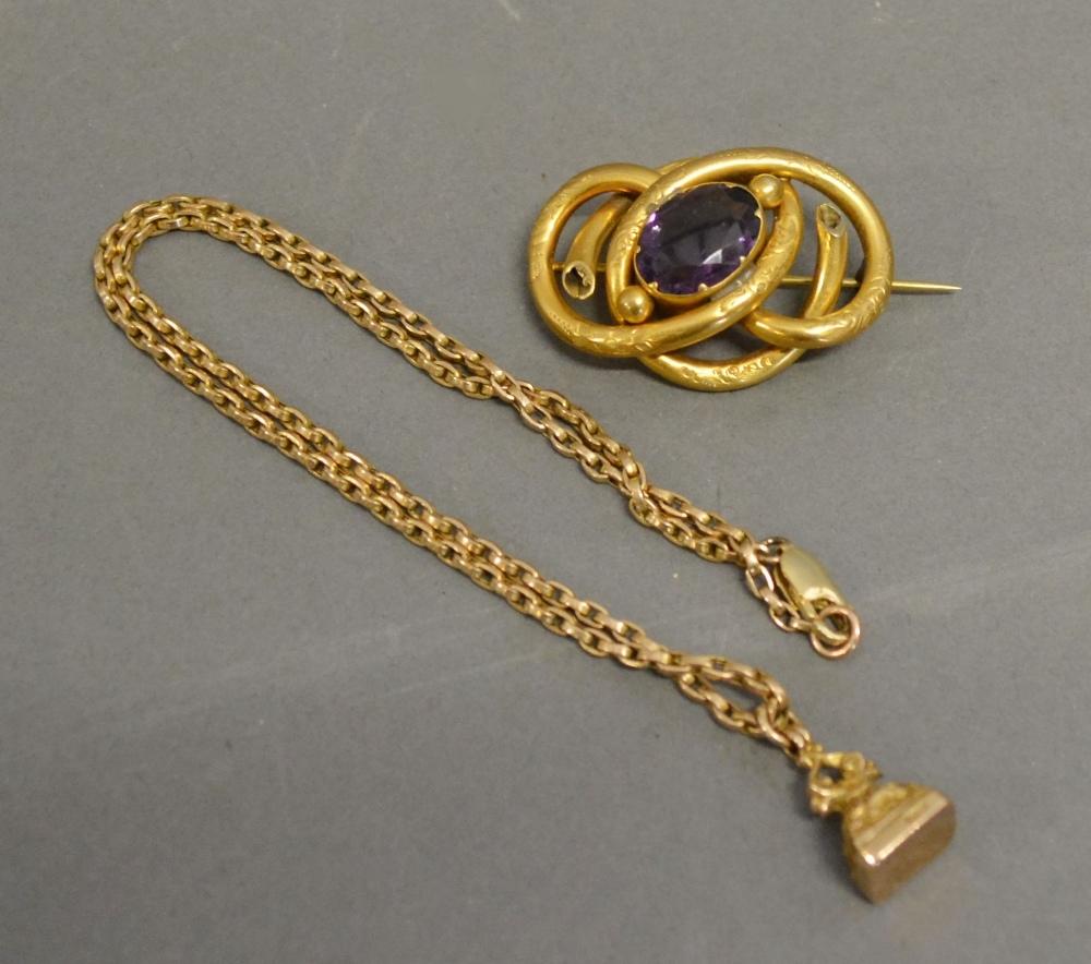 A 9ct. Gold Seal Fob with Chain together with a yellow metal brooch set oval amethyst