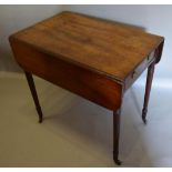 A Regency Mahogany Pembroke Table with an end drawer opposed by dummy drawer, raised upon turned