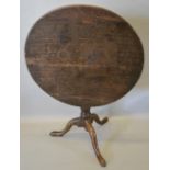 A 19th Century Oak Pedestal Table, the circular top above a turned centre column raised upon