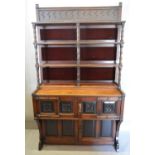 An Arts and Crafts Cabinet, the carved shelf back with turned pilasters with red velvet panels,