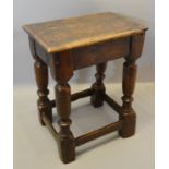 An 18th Century Oak Joint Stool, the moulded top above turned legs with stretchers