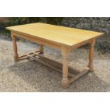A Light Oak Refectory Style Dining Table, the plank top above a plain frieze with turned legs and