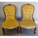 A Pair of Victorian Walnut Drawing Room Spoon Back Chairs, each with a carved and button upholstered