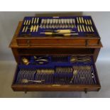 A Canteen of Cutlery by George Ibberson & Co. Sheffield, housed within an oak cabinet, the moulded