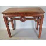 A 19th Century Chinese Hardwood Rectangular Altar Table with a pierced frieze raised upon square