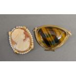 An Oval Cameo Pendant Brooch within 14ct. Gold Pearl set frame together with a Tiger's Eye Brooch