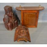 An Edwardian Mahogany Wall Cabinet together with two figural carvings