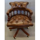 A Reproduction Mahogany and Leather Revolving Office Armchair with buttoned leather back and seat