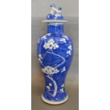 A Chinese Baluster Form Vase and Cover decorated with prunus blossom, the lid surmounted with a