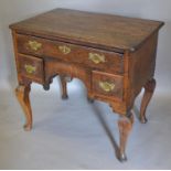 A George III Oak Low Boy, the moulded top above three drawers with brass handles, raised upon