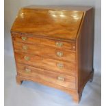 A George III Mahogany Bureau, the fall front enclosing a fitted interior above four long drawers