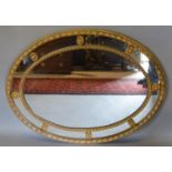 A French Oval Gilded Sectional Wall Mirror, 75 x 100 cms