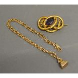 A 9ct. Gold Seal Fob with Chain together with a yellow metal brooch set oval amethyst