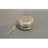 A Sterling Silver Yo Yo of Embossed Foliate Scroll Form