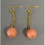 A Pair of Yellow Metal Drop Earrings both with coral bead drops