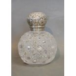A Silver Topped and Cut Glass Large Scent Bottle of globular form, 15 cms tall