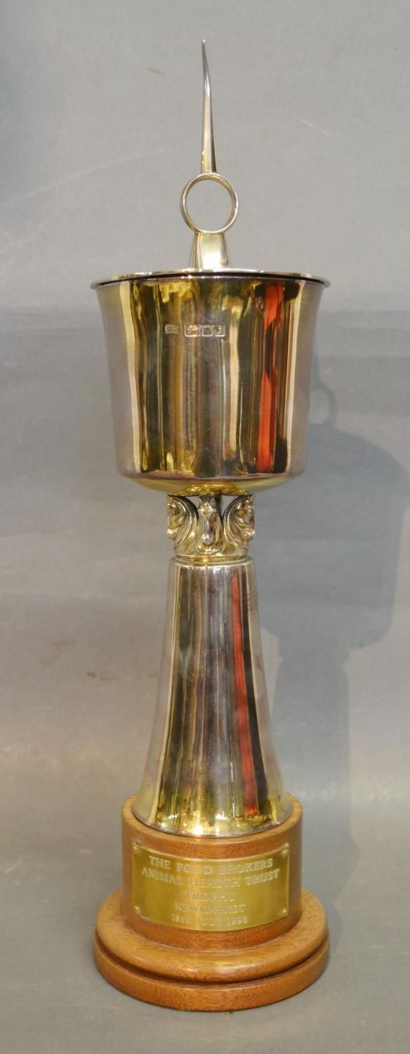 A London Silver Presentation Covered Trophy Cup of Stylised Form with circular wooden plinth, 18