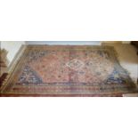 A North West Persian Large Rug with a central medallion within an all over design upon a red, blue