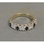 An 18ct. White Gold Sapphire and Diamond Half Eternity Ring, set with four diamonds and five