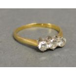 An 18ct. Gold Three Stone Diamond Ring, the three stones claw set