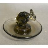 A Lalique Smoke Glass Pin Tray surmounted with a model of a rabbit etched R. Lalique, France