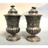 A Pair of George IV Silver Sanders with removable tops and scroll foliate embossed bodies, London