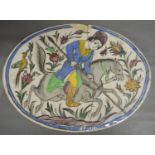 A Persian Oval Plaque with polychrome decoration, 27 x 37 cms