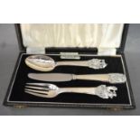 A Scandinavian White Metal Three Piece Christening Set, in later case