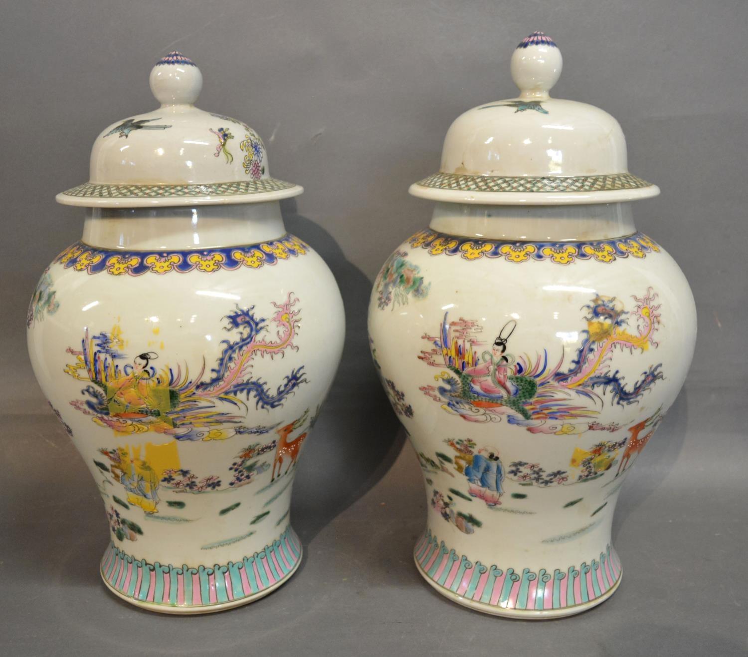 A Pair of Canton Porcelain Covered Vases, decorated in polychrome enamels highlighted with gilt,