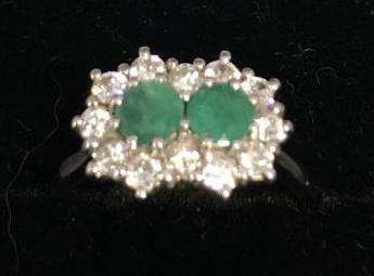 An 18ct. White Gold Double Emerald and Diamond Cluster Ring, set with two emeralds surrounded by