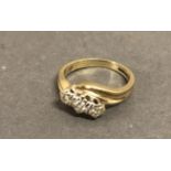 A 9ct. Gold Three Stone Diamond Crossover Ring