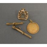 A 15 ct. Gold Medallion, 4.7 gms, together with a seal, a gold bar brooch and a small propelling