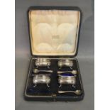 A Set of Four Birmingham Silver Salts with Blue Glass Liners and Spoons within fitted lined case,