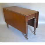 A Victorian Mahogany Drop Flap Dining Table, with turned tapering reeded legs