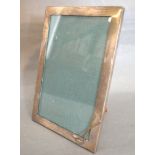 A Birmingham Silver Rectangular Photograph Frame mounted with two Golf Clubs, 19 by 13 cms