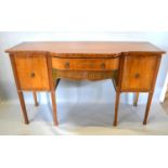 A Mahogany Semi Bow Fronted Sideboard with a frieze drawer flanked by cupboard doors with lion