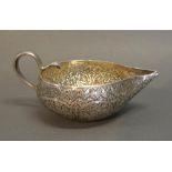 An Eastern White Metal Jug With Shaped Handle, 7 oz