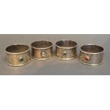 Guild Of Handicrafts A Set Of Four London Silver Napkin Rings, each set with cabochon stones, London