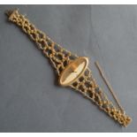 An 18ct. Gold Cased Ladies Wristwatch by Ebel with shaped pierced bracelet, 52.2 gms all in