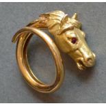 An 18ct. Gold Heavy Ring In The Form Of A Horses Head, the eyes set with rubies, 11.9 gms