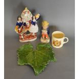 A 19th Century Staffordshire Clock Group, together with a Staffordshire pepper, a green leaf plate