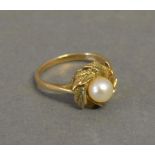 A 9ct. Yellow Gold Dress Ring set with single pearl within a wreath setting