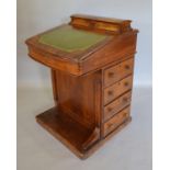 A Victorian Walnut Marquetry Inlaid Davenport with a domed stationary compartment above a leather