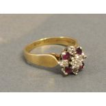 A 9 ct. Yellow Gold Diamond And Ruby Cluster Ring, set with four rubies interspersed with diamonds