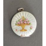 A Small White Enamel Locket Decorated With A Basket Of Flowers