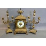 A Victorian Brass Three Piece Clock Garniture, the enamel dial with Arabic numerals and two train