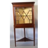 An Edwardian Mahogany Satinwood Inlaid Standing Corner Cabinet, the moulded cornice above an