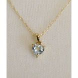 A 10 ct. Gold and Aquamarine Pendant with linked chain